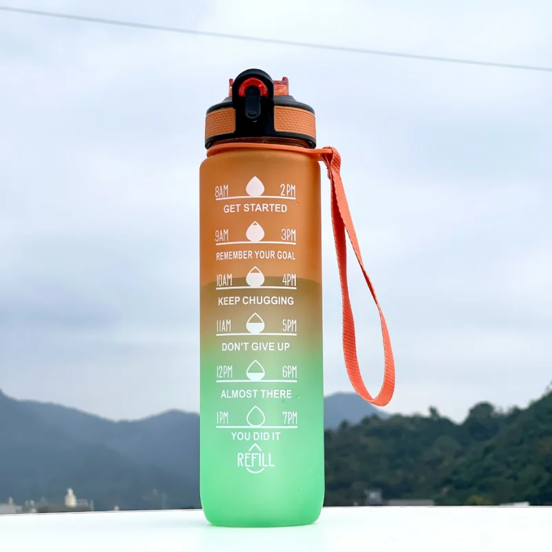 Gradient water bottle with motivational text against a scenic background