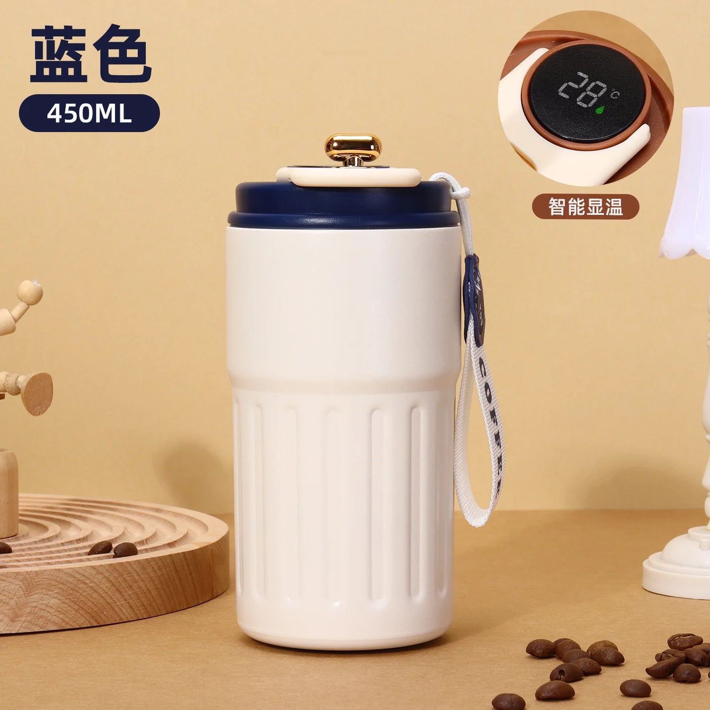 White ceramic mug with blue lid on a beige surface, surrounded by coffee beans and a digital thermometer.