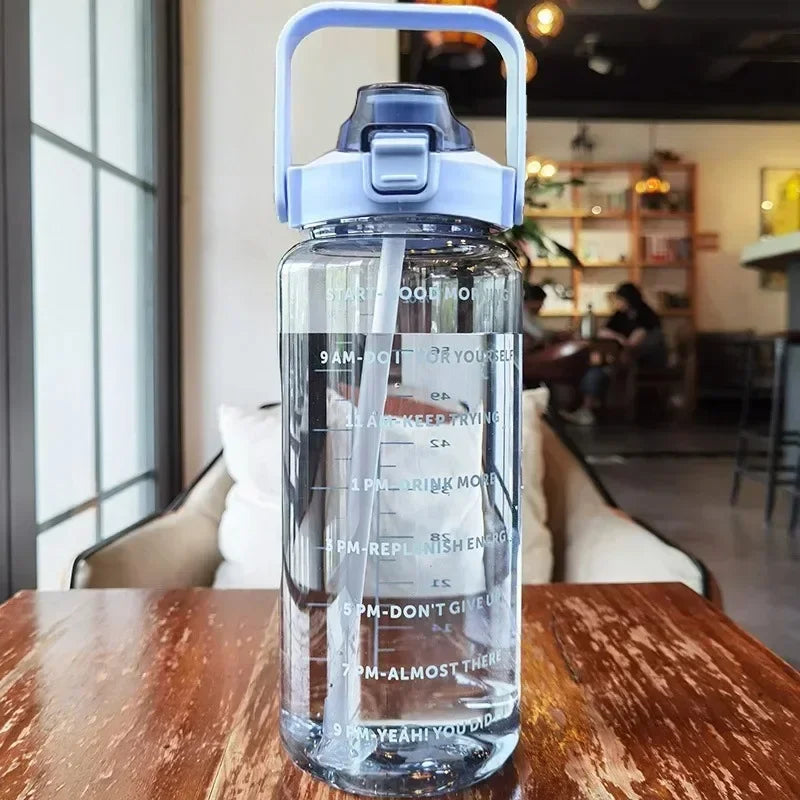 Clear water bottle with blue cap on a wooden table in a cafe setting