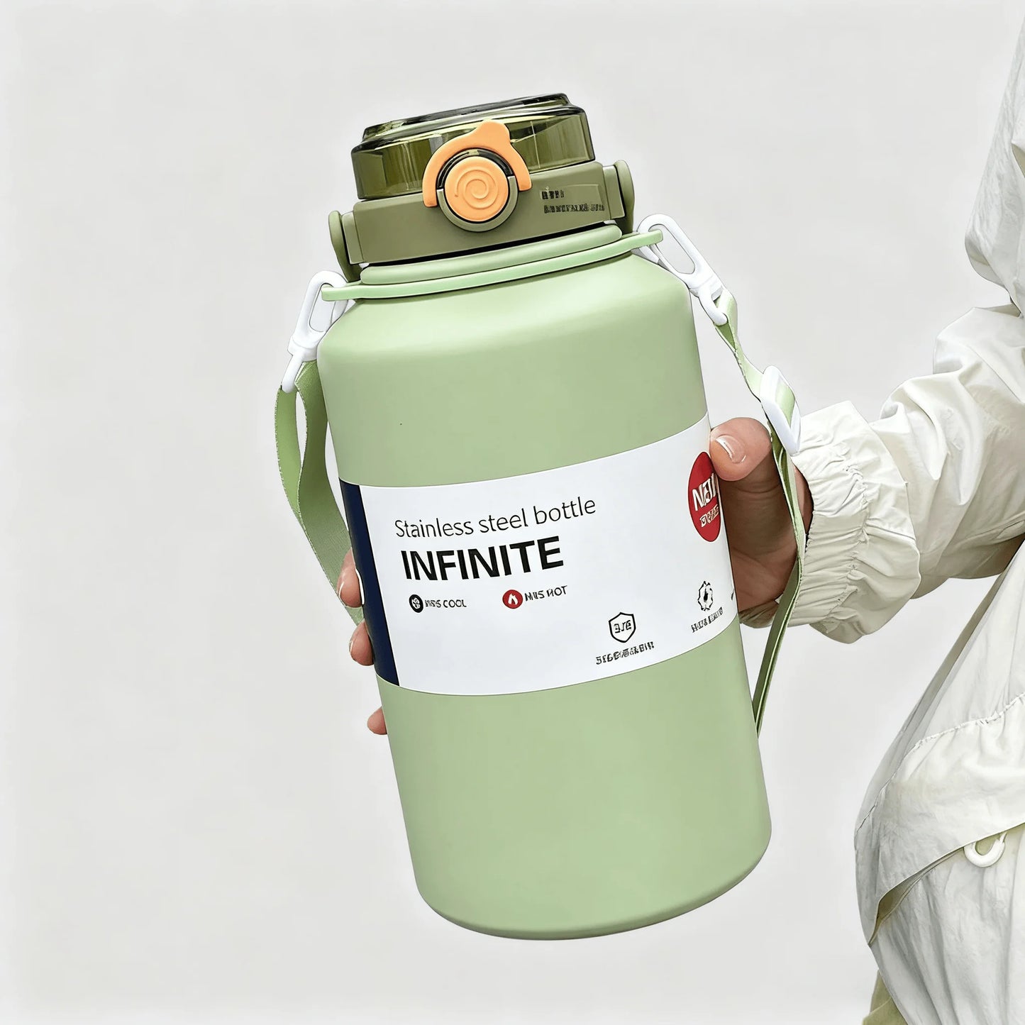 Green stainless steel bottle labeled 'INFINITE' held by a person wearing a white jacket.
