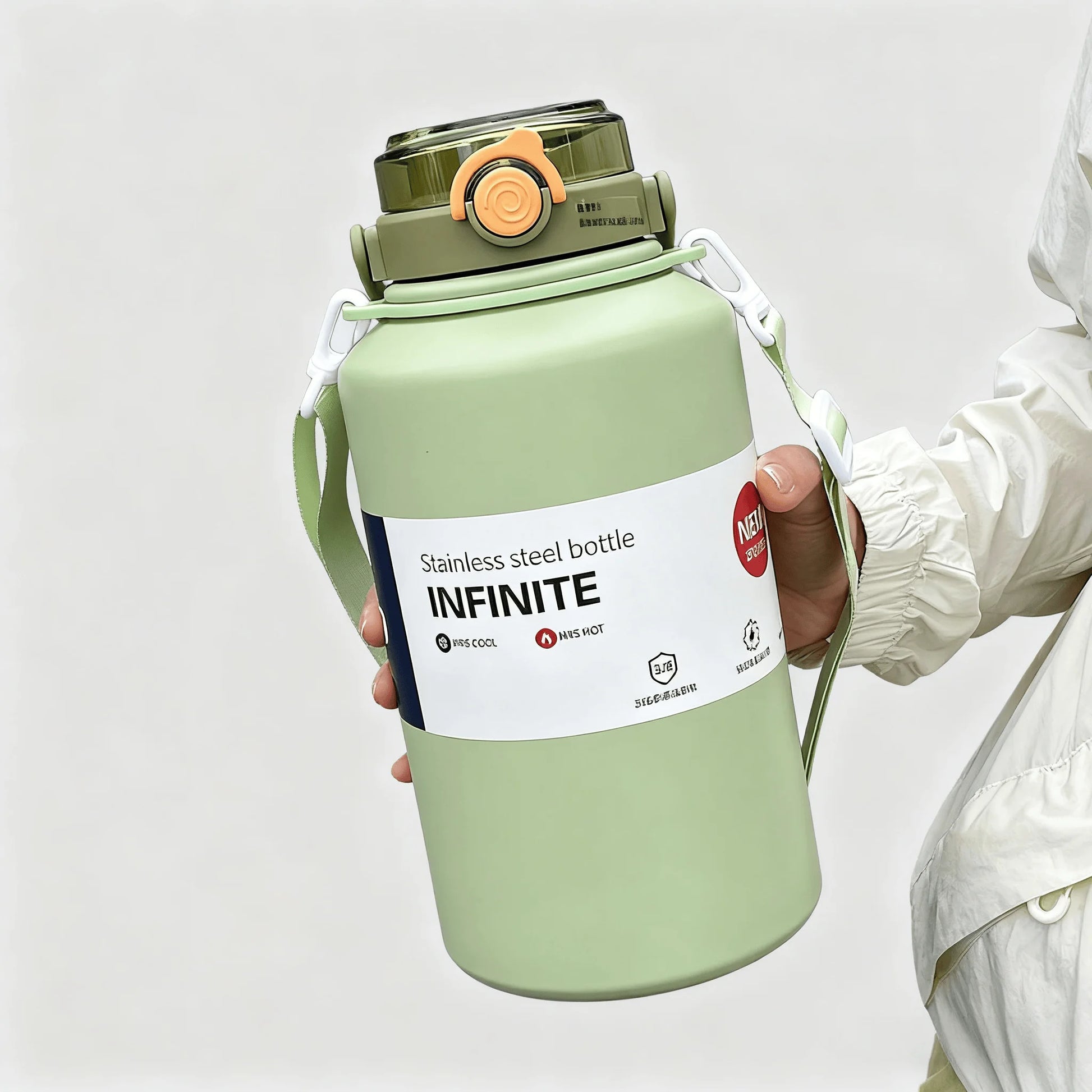 Green stainless steel bottle labeled 'INFINITE' held by a person wearing a white jacket.
