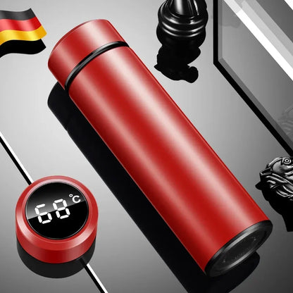 Red thermos bottle with digital temperature display on a reflective surface