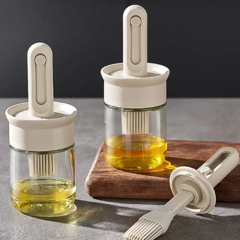 Two glass containers with white lids and a brush on a gray surface.
