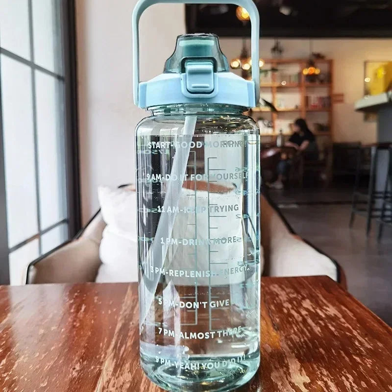 Clear water bottle with measurements on a wooden table in a cafe setting