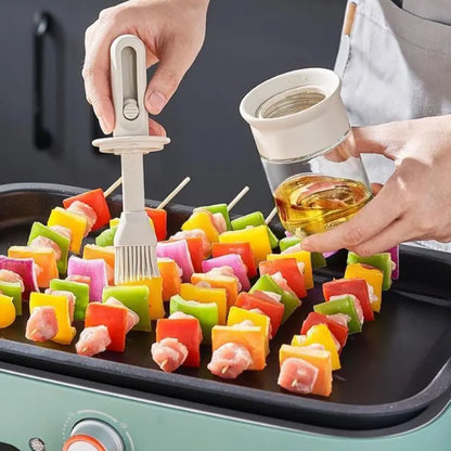 Colorful skewers being prepared on a grill with a hand holding a bottle of oil.