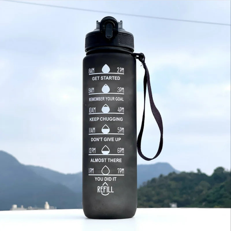Black motivational water bottle with scenic background