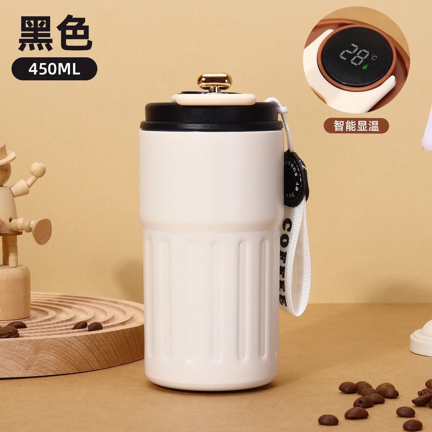 White coffee tumbler with black lid on a beige background, featuring coffee beans and a digital thermometer.