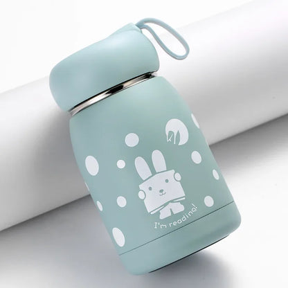 Light blue thermos bottle with white cartoon design on a light gray background