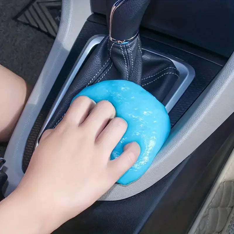 Hand using a blue gear shift cover in a car