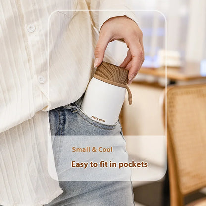 Person holding a small brown bag with text 'Small & Cool, Easy to fit in pockets' in an indoor setting.