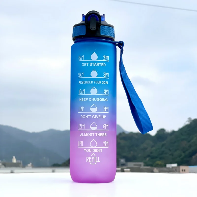 Gradient blue to purple water bottle with motivational text against a mountainous background