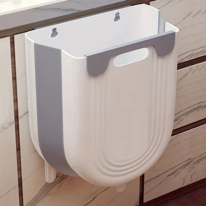 Wall-mounted white and gray pet toilet on a wooden floor with a marble-patterned wall.
