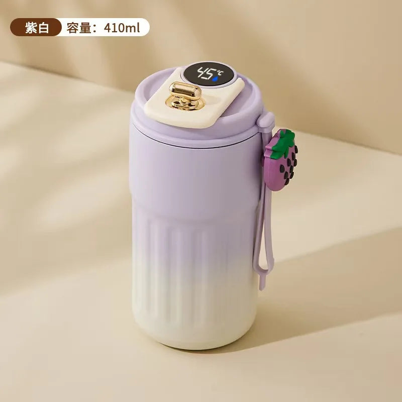 Purple and white thermos with digital temperature display on a beige background