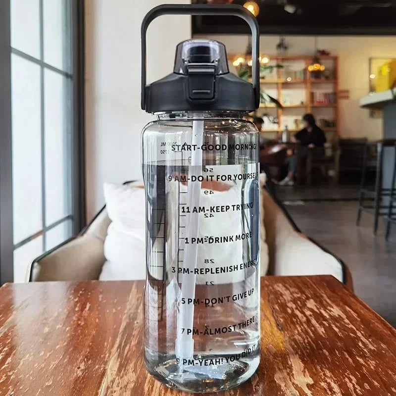 Clear water bottle with black lid on a wooden table in a cafe setting