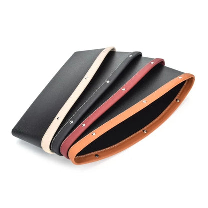 Set of black leather belts with beige, red, and brown straps on a white background