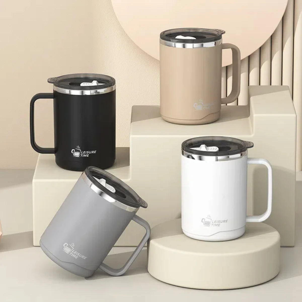 Four insulated mugs in black, beige, gray, and white on a neutral background
