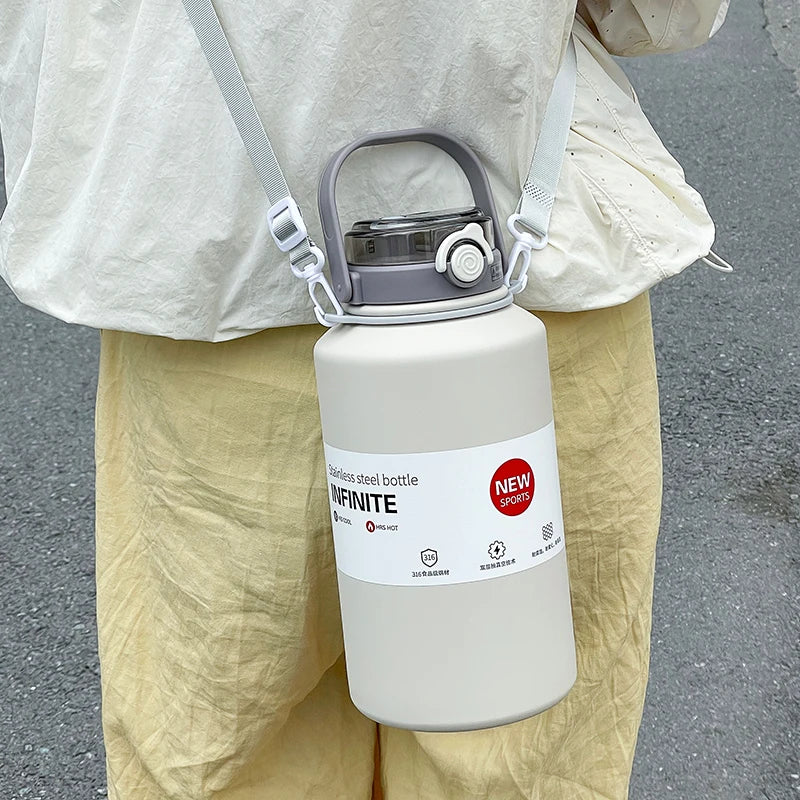 Person holding a large white water bottle with a label, wearing a light-colored outfit.