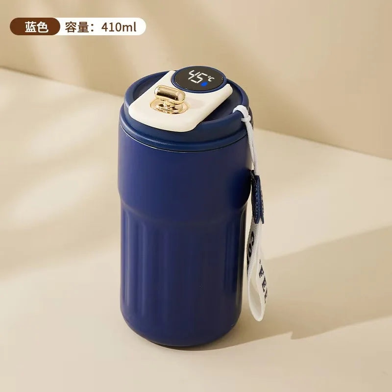 Blue thermos with digital temperature display on a beige background