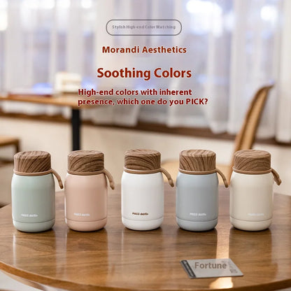 Five insulated containers with wooden lids on a table, featuring Morandi Aesthetics branding.